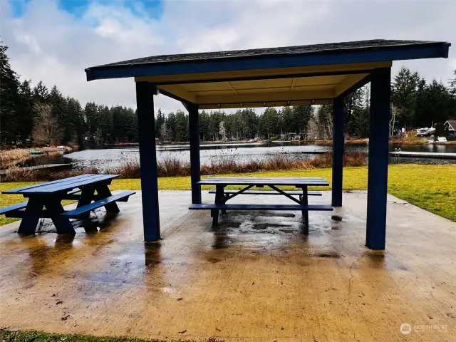 Covered picnic area lakeside with both swimming and fishing docks.