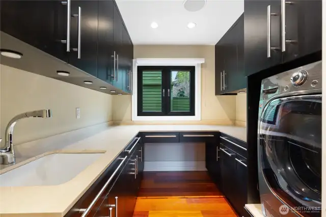 Deluxe laundry room with granite counters and cabinets galore