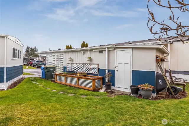 Back side of carport w/ 2nd storage shed.