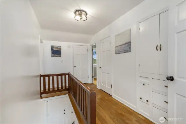 Second floor landing area with Oak hardwoods, built in storage and multiple closets.