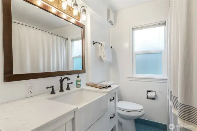Renovated upper bedroom with new cabinet, sink basin, fixtures and accessories.