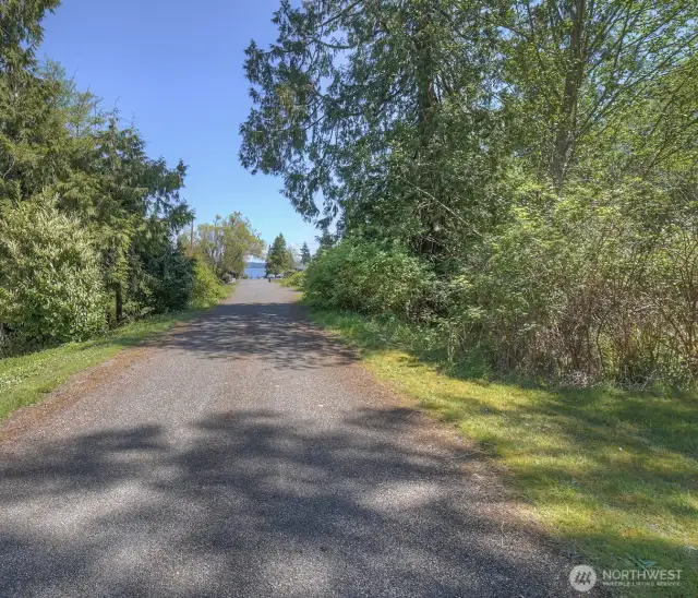 Standing in front of the property which is on the right side of the photo and looking over towards the water.