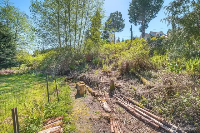 This fencing is not the property line. The Seller has been clearing the upper portion of the property which continues and slopes up to Fir St.