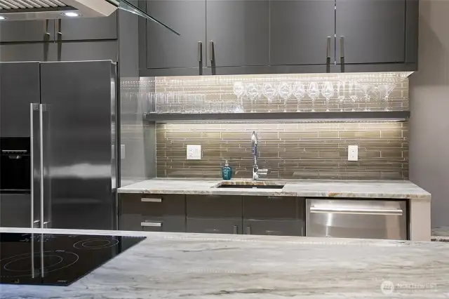 Mosaic glass tile and dramatic lighting up the wow factor.