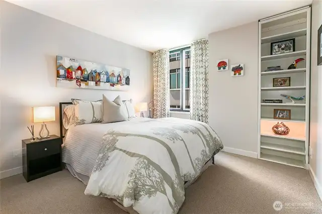 Lovely guest space with built-in shelving and new carpeting.