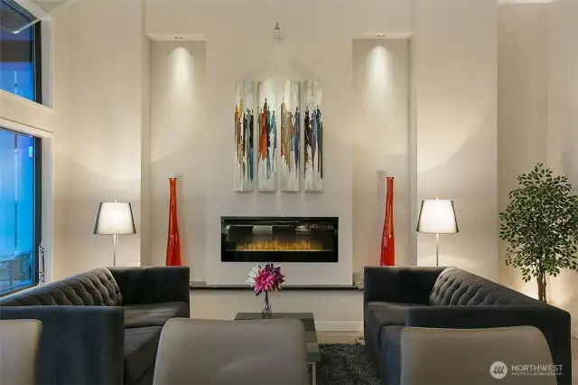 Stunning symmetry in the living room with art niches and a modern electric fireplace.