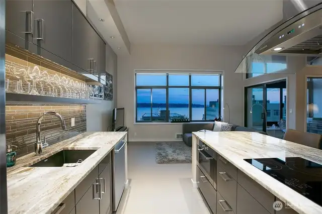 Twilight views from the kitchen. Cool, modern tile floors run throughout the main living spaces.