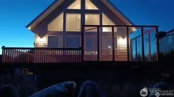 Night view of home and outside sitting area protected from wind