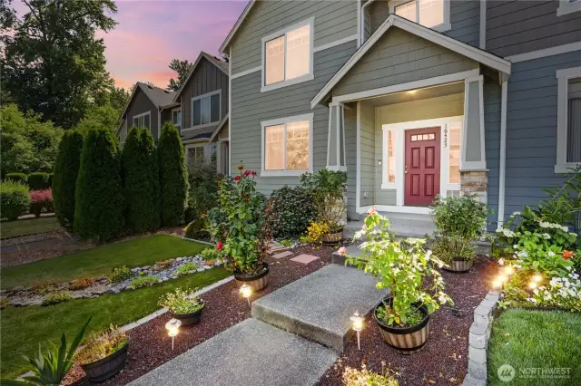 Welcome Home! Turf lawn, easy-care plantings and landscape. Solar lights make the entry extra welcoming!