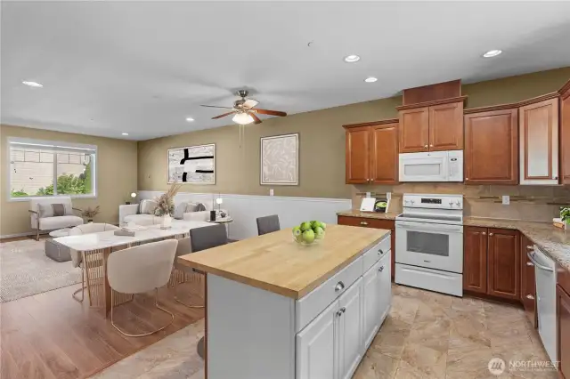 Notice the Island cabinets are white, as an accent, which flows fabulously with the accent wall and white appliances.