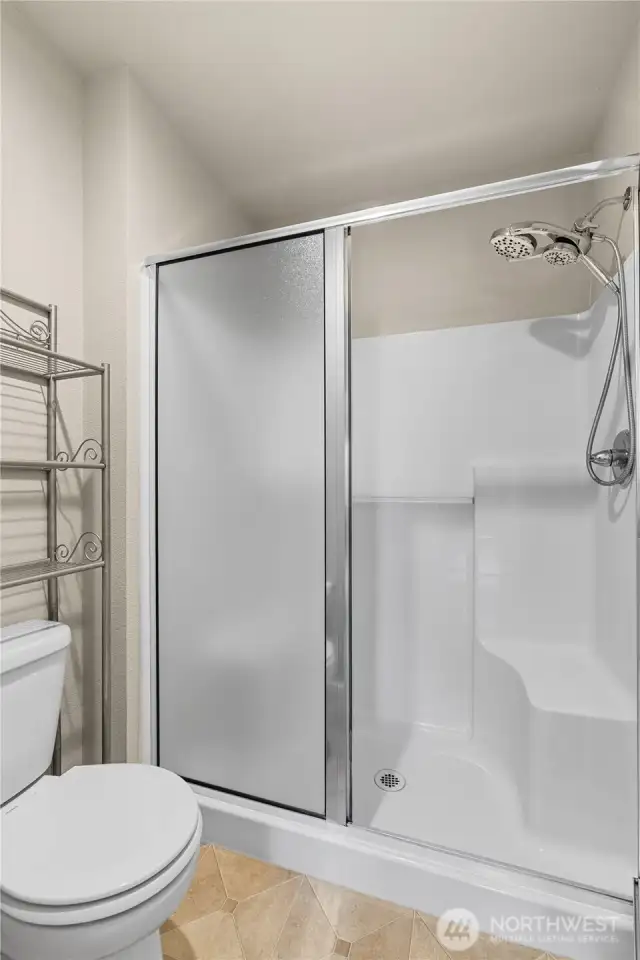 Primary En Suite Bath continues w/an Oversized Shower w/Bench and Upgraded Shower Head.