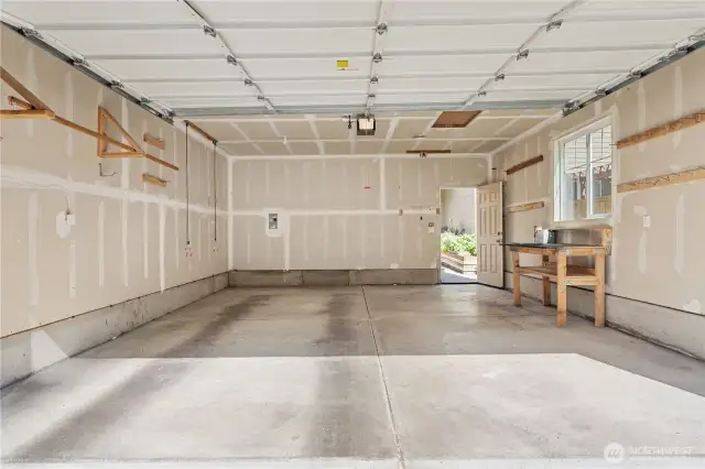 Very Clean Garage is fully finished with window and door to backyard. Garage Door comes with opener. Work Bench stays