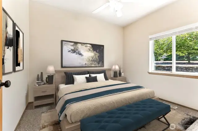 Virtually staged bedroom with carpet flooring. Closet with built-in custom shelving and storage is to the right of the photo and ceiling fan.