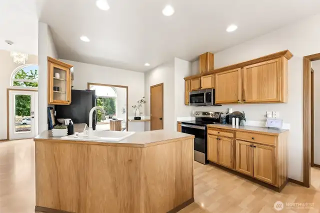 Beautifully laid out open-concept kitchen, living room, dining room with large amounts of storage and counter space with natural oak cabinetry, porcelain white sink, new appliances with natural light galore. Enjoy the hard surface hardwood laminate flooring throughout.