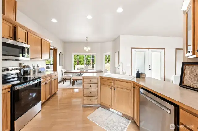 Beautifully laid out open-concept kitchen, living room, dining room with large amounts of storage and counter space opening up to the dedicated eat-in dining area, ideal for entertaining.