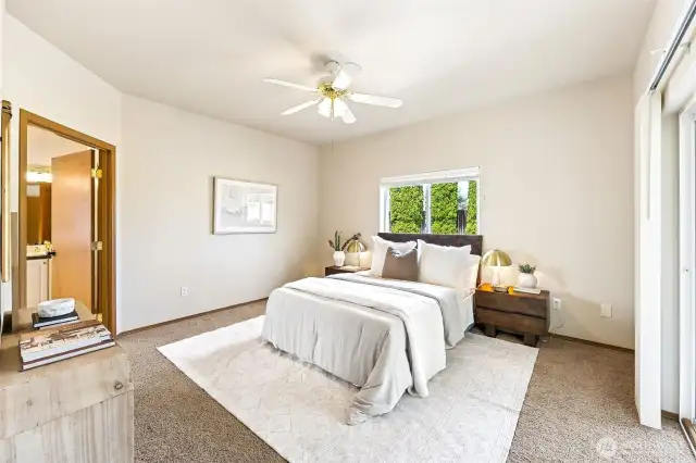 Primary Suite of your dreams. With a patio slider leading to the large, covered patio area, multiple windows and ceiling fan.