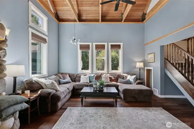 This spacious living room will entice you with an abundance of natural light. Elegant hickory wood stairs lead to each of the two wings of the home, and beautiful bamboo flooring can be found throughout the downstairs main level.