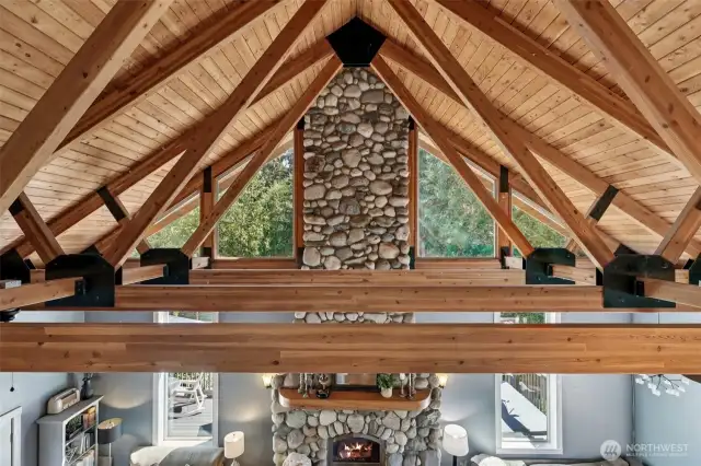 Exposed beams, natural ceiling and tall windows add to the elegance and splendor of the living room.