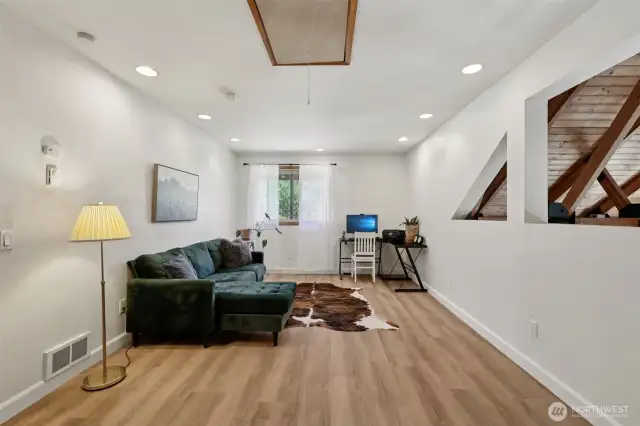 Off the main living room and up the stairs, you will find a spacious office or flex space with new LVP flooring (2025) before heading towards the primary suite. This area of the home is known as Wing 1 or the Primary Wing.