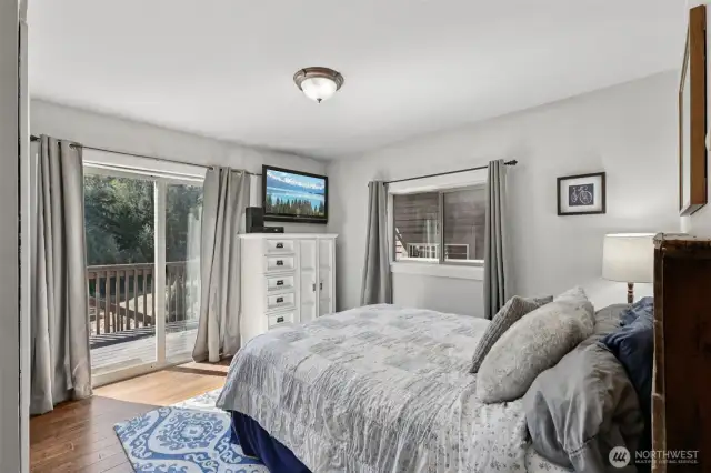 This main floor bedroom features its own private access to one of the decks off the front of the home.