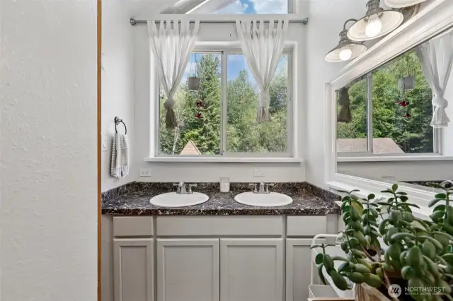 Full bathroom with ample storage located in the second wing of the home.