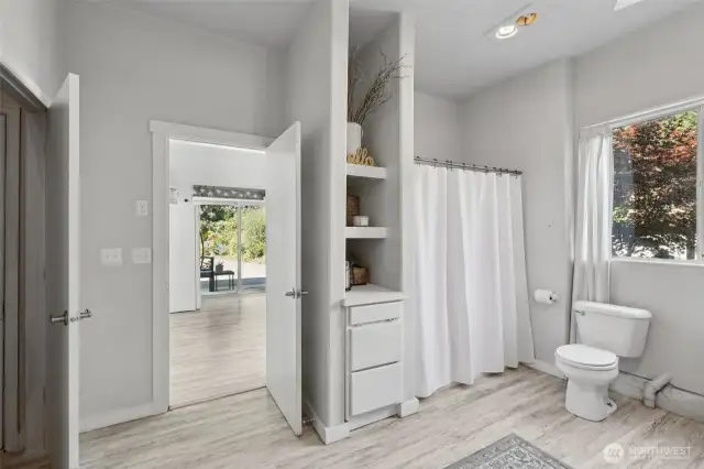 Downstairs from the main floor of the home, you will find this large full bathroom complete with the laundry and utility space.