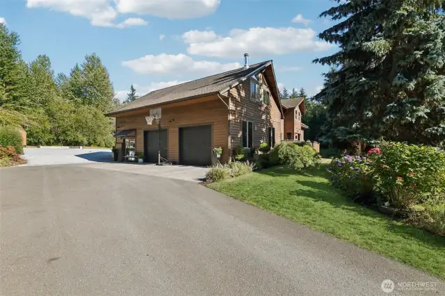Large two-car garage with plenty of storage and 220V power.