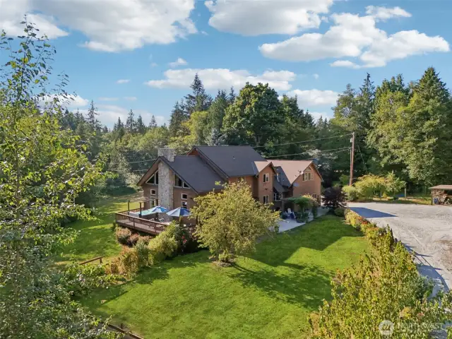 Stunning view of the river rock fireplace and back deck that has the hot tub.