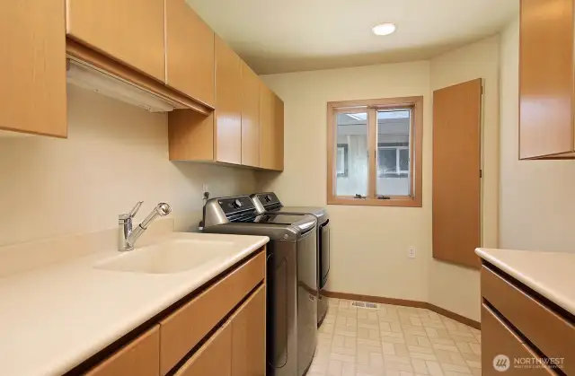 Spacious utility room is located on the main with tons of storage and built-in ironing board.