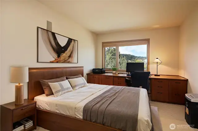 The den is located on the main level and offers tons of built-in cabinets.