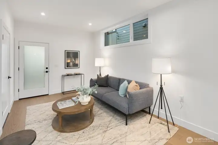 Living room is on the main floor. The door in this photo leads out to the courtyard which separates the detached house from the carriage house.