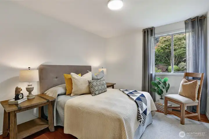 Spacious main floor bedroom #1, looking into beautiful backyard.