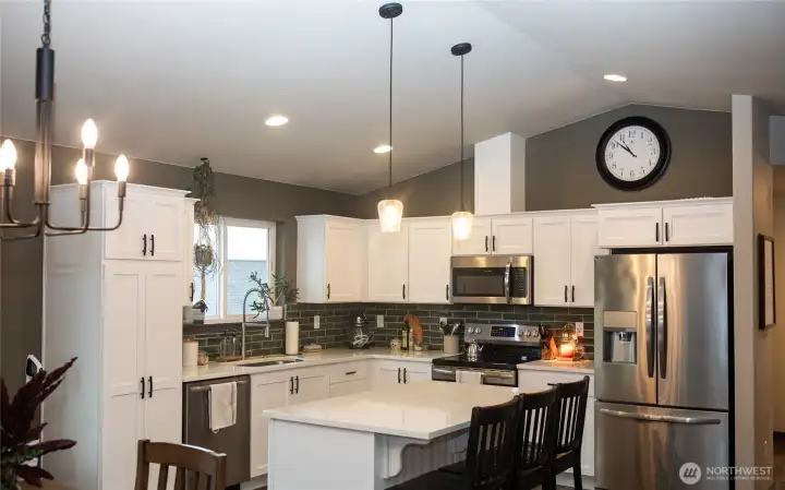 Kitchen with large island finished in Quartz countertops.