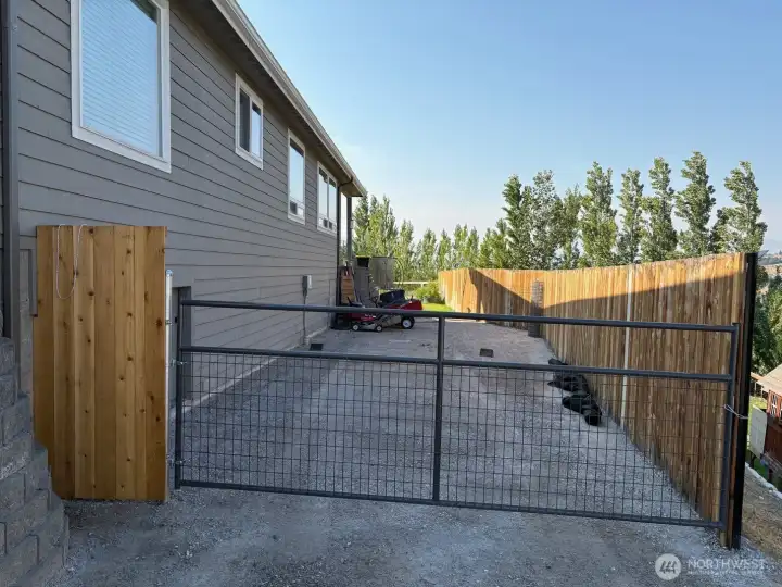 Large parking area and access to backyard.