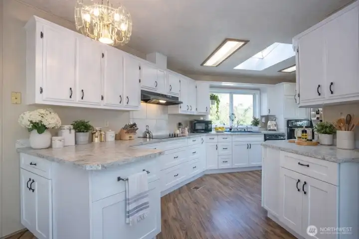 Ample cabinetry and sleek, spacious counters create an ideal setting for effortless meal prep and entertaining. A full suite of sleek stainless-steel appliances adds contemporary elegance.
