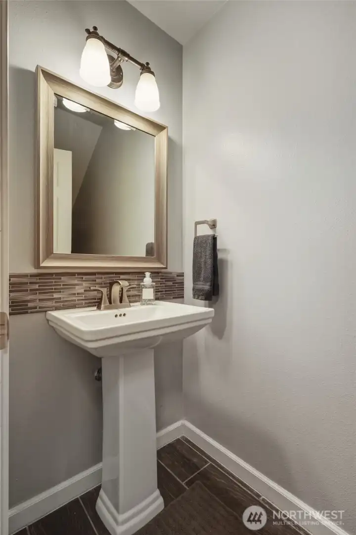 Powder room off hallway on main level.