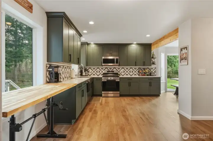 The adjustable "butcher block" table to the left works extremely well as a movable island ... it will stay with the house unless Buyer doesn't want it.