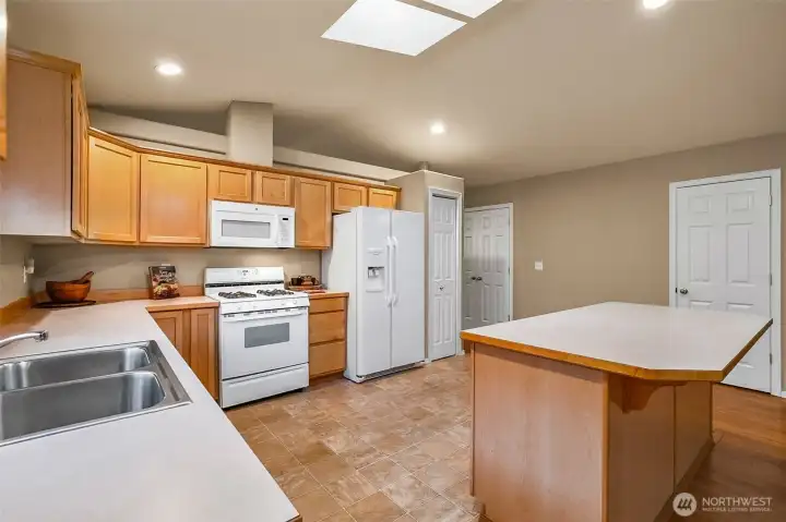 Two pantry closets, skylight, island, gas stove.