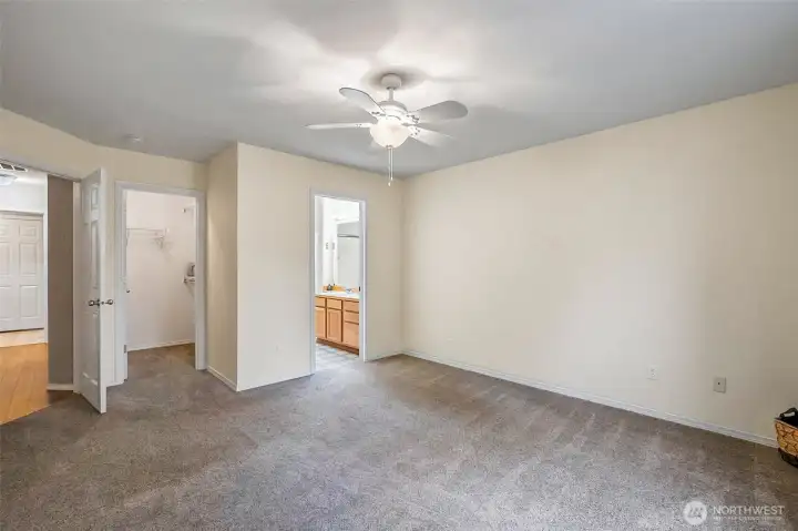 Spacious primary suite with private bathroom and walk in closet.