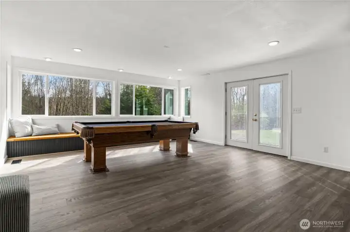 This large light filled bonus space is part of the family room. Through the french doors leads you to the back patio and yard.