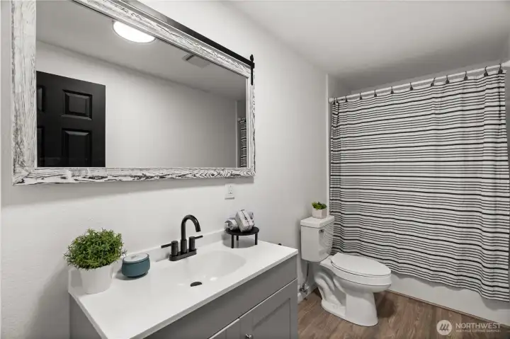 The large full bath on the main level located in between the primary and secondary bedroom.