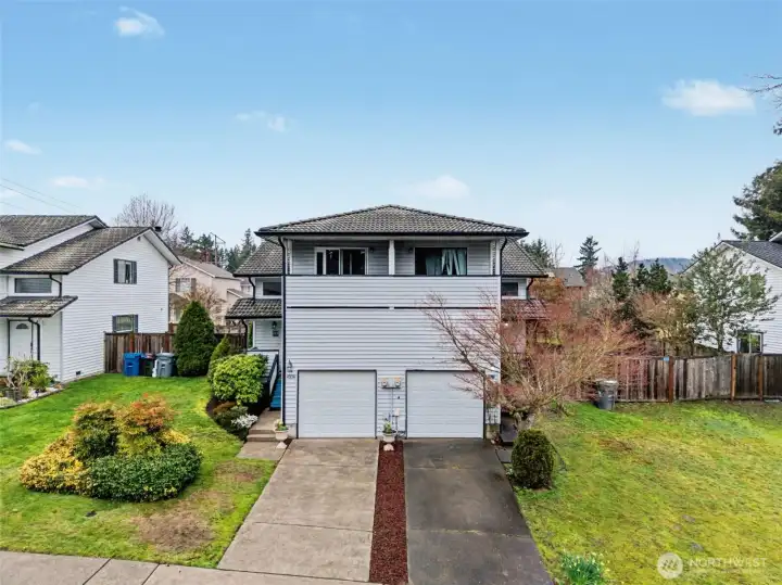 Welcoming front exterior of this well-maintained townhome, ideally situated in a quiet setting.