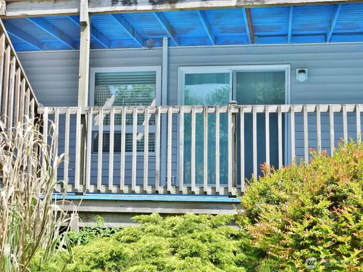 Rear view of Unit #106 w/ slider door out to the deck.