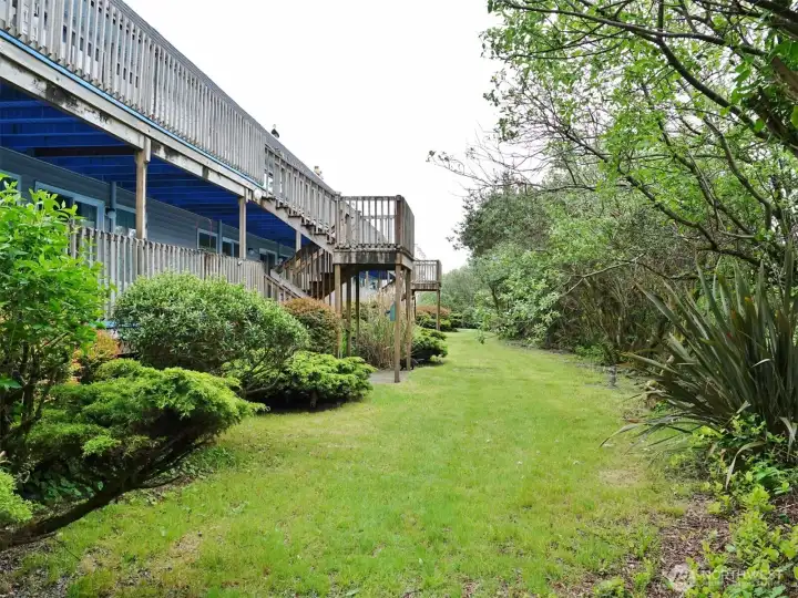 Ocean Surf building's privately situated backyard with mature landscaping.