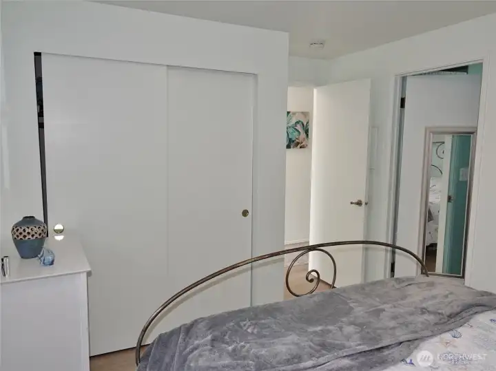 Bedroom w/ closet and access to the bathroom.