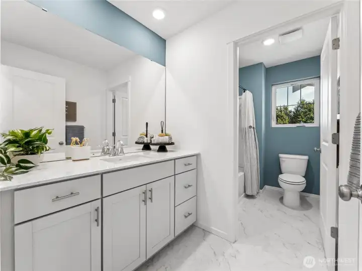 Secondary bath upstairs with a lot of storage, handles, and quartz countertops. Pictures are for representational purposes only, colors and features may vary. Secondary bath upstairs with a lot of storage, handles, and quartz countertops. Pictures are for representational purposes only, colors and features may vary.
