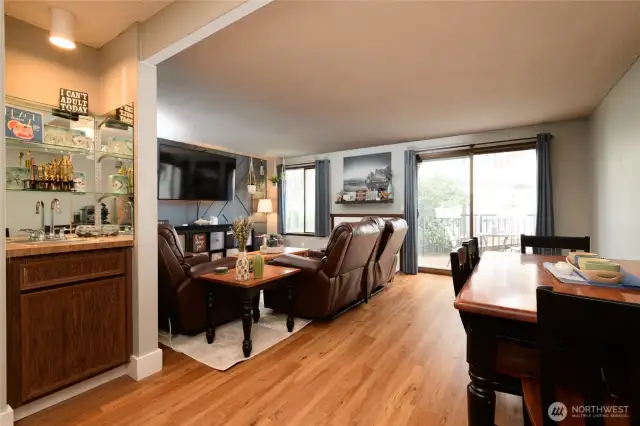 From the dining area the floor plan opens directly to the living room with fireplace and back deck to the lagoon. The adjacent wet bar adds convenience for entertaining guests.