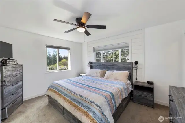 Upstairs primary suite with walk-in closet and full bath