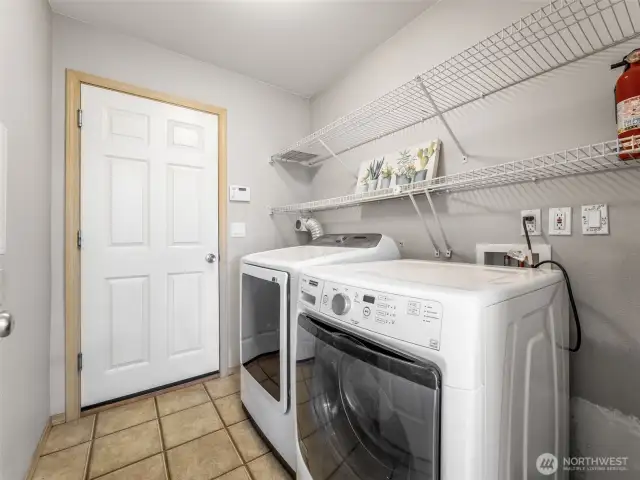 Just off the kitchen is the laundry room, and this door leads to the 2 car garage.