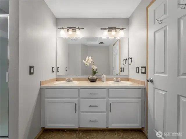 Primary bath includes freshly painted vanity with two sinks and LOADS of storage.